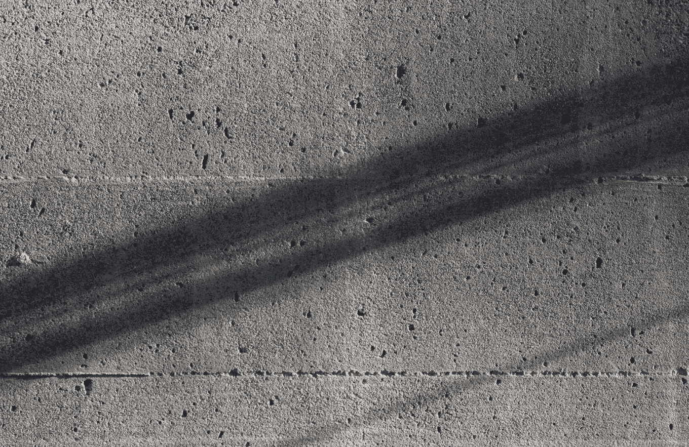 image of grainy grey brick wall with a shadow on it